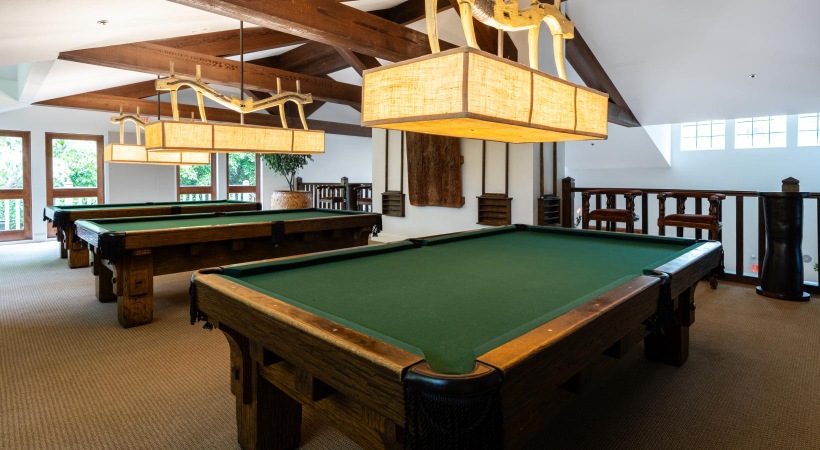 pool tables in a room with windows